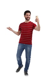Photo of Smiling man taking selfie with smartphone on white background