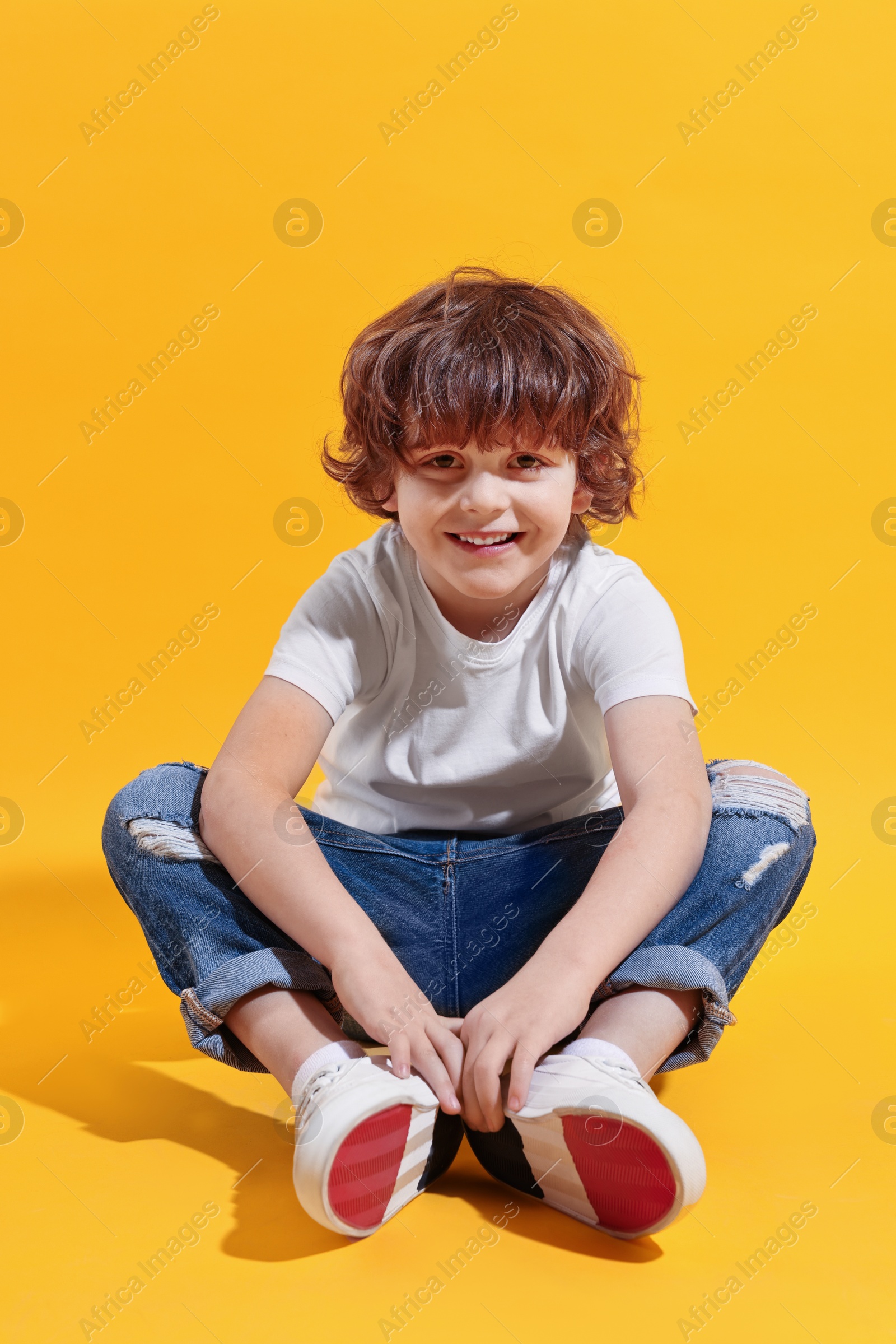 Photo of Fashion concept. Stylish boy posing on yellow background