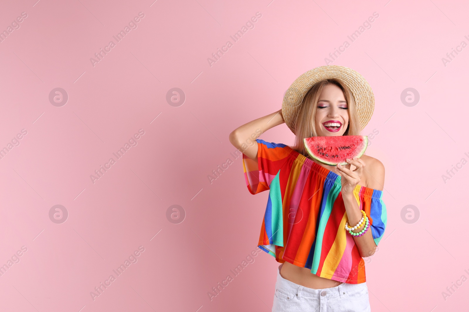 Photo of Pretty young woman with juicy watermelon on color background