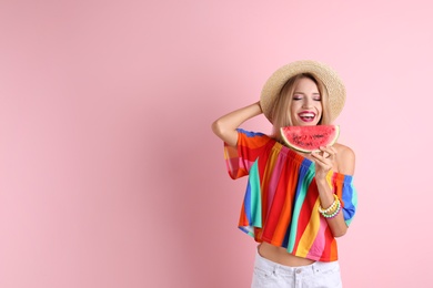 Pretty young woman with juicy watermelon on color background