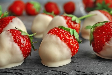 Chocolate covered strawberries on slate plate, closeup