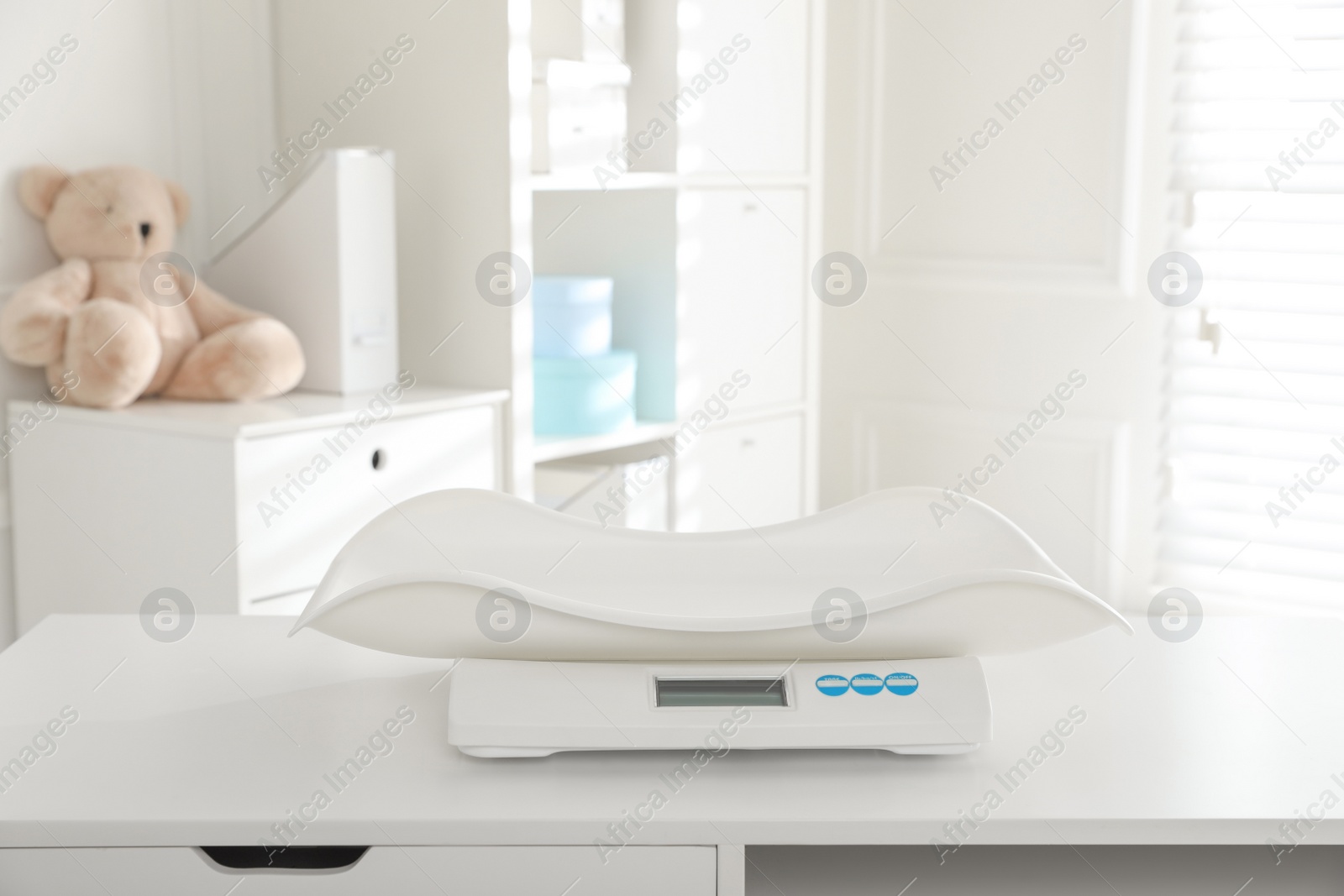 Photo of Modern digital baby scales on table in clinic