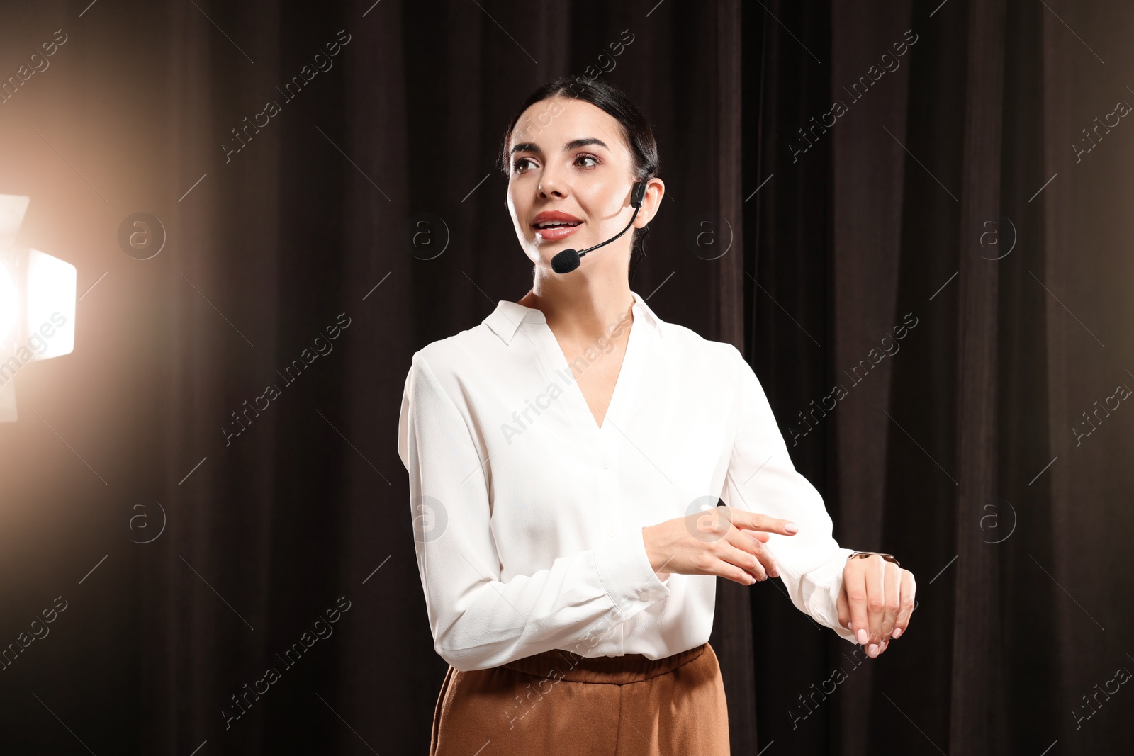 Photo of Motivational speaker with headset performing on stage