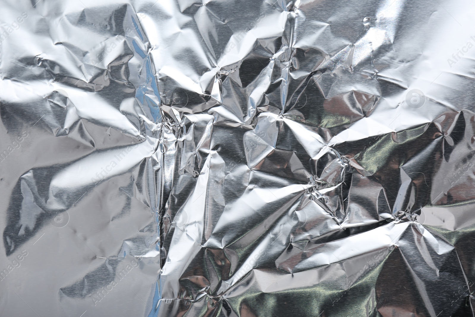 Photo of Crumpled silver foil as background, closeup view