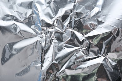 Crumpled silver foil as background, closeup view