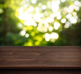 Image of Empty wooden surface against blurred green background. Space for design