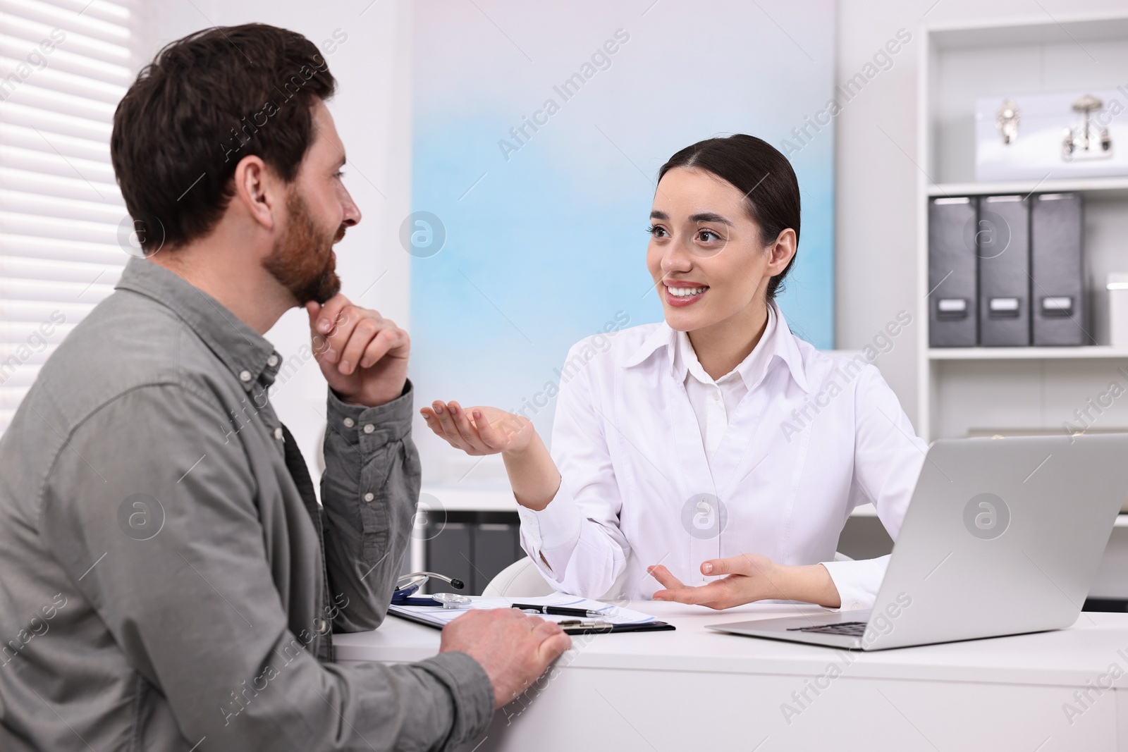 Photo of Doctor consulting patient during appointment in clinic