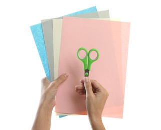 Woman holding color sheets of paper and scissors on white background, closeup