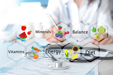 Image of Nutritionist's recommendations. Doctor working at table in office, closeup