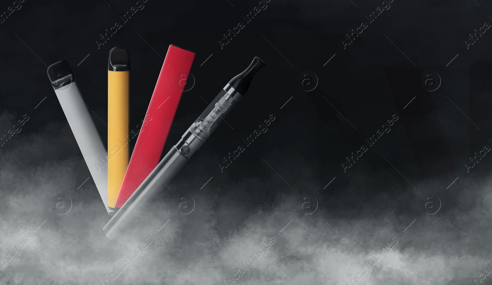 Image of Different electronic smoking devices on black background. Space for text