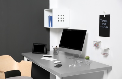 Photo of Modern interior of workplace with computer and accessories