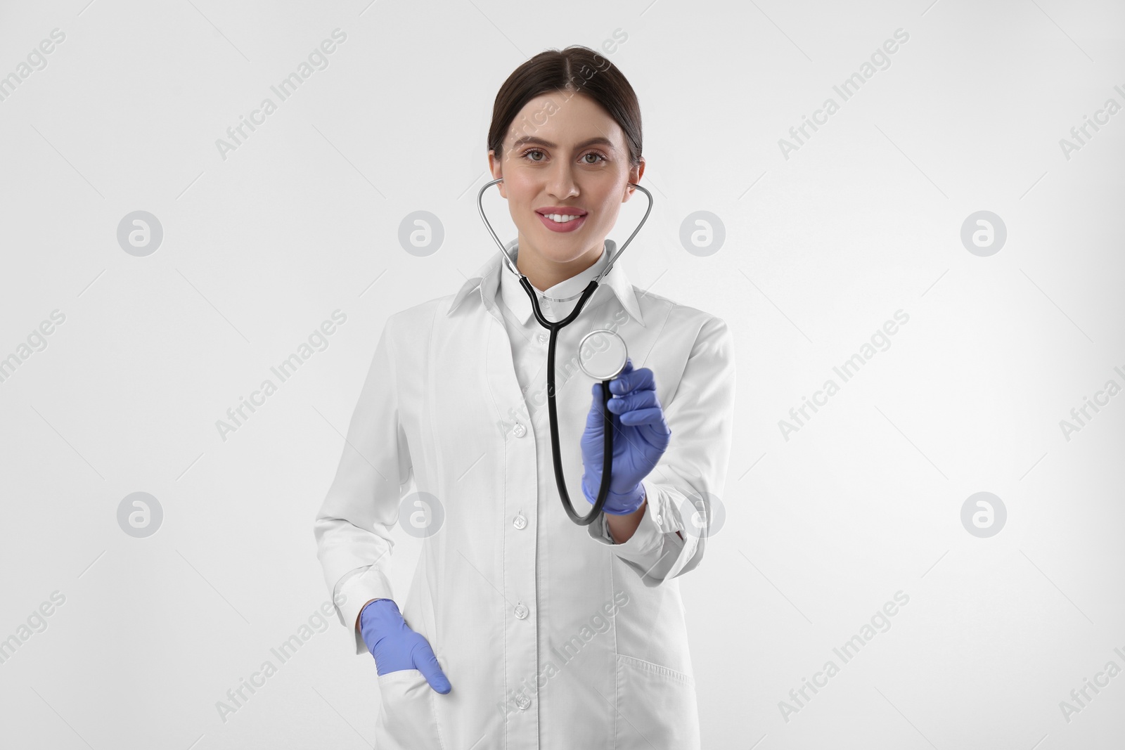 Photo of Doctor with stethoscope on white background. Cardiology concept