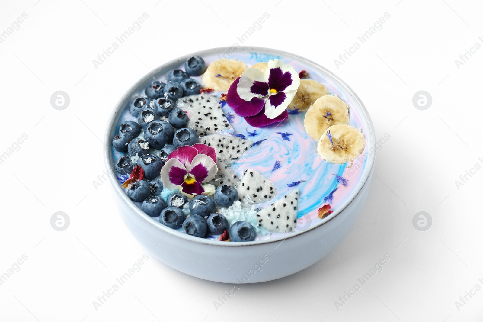 Photo of Delicious smoothie bowl with fresh fruits, blueberries and flowers on white background