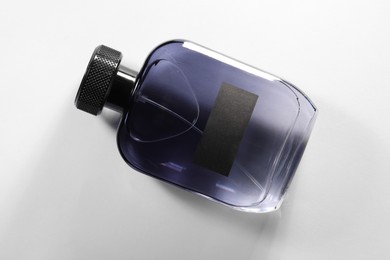 Luxury men`s perfume in bottle on white background, top view