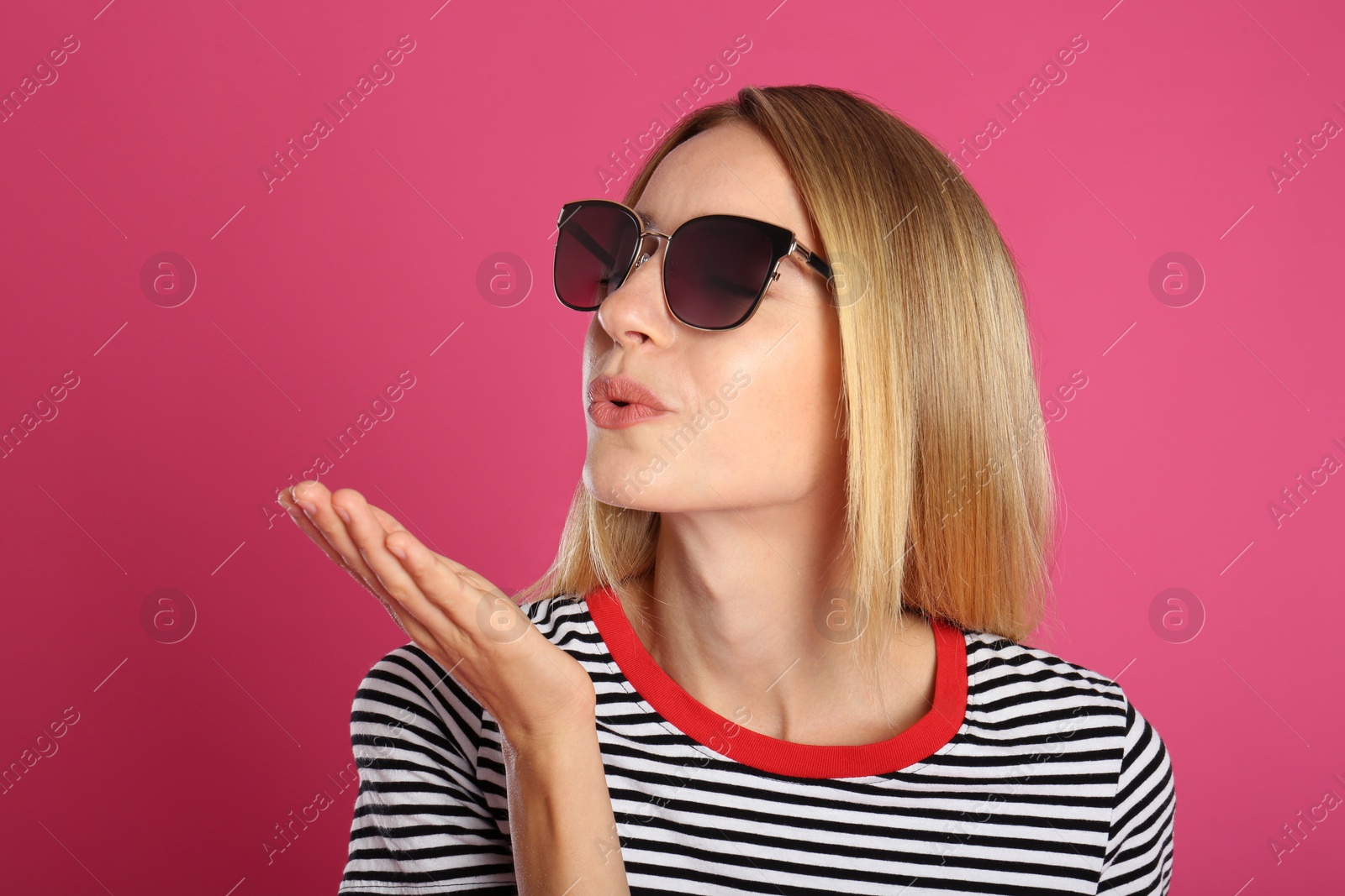 Photo of Beautiful woman in stylish sunglasses on pink background