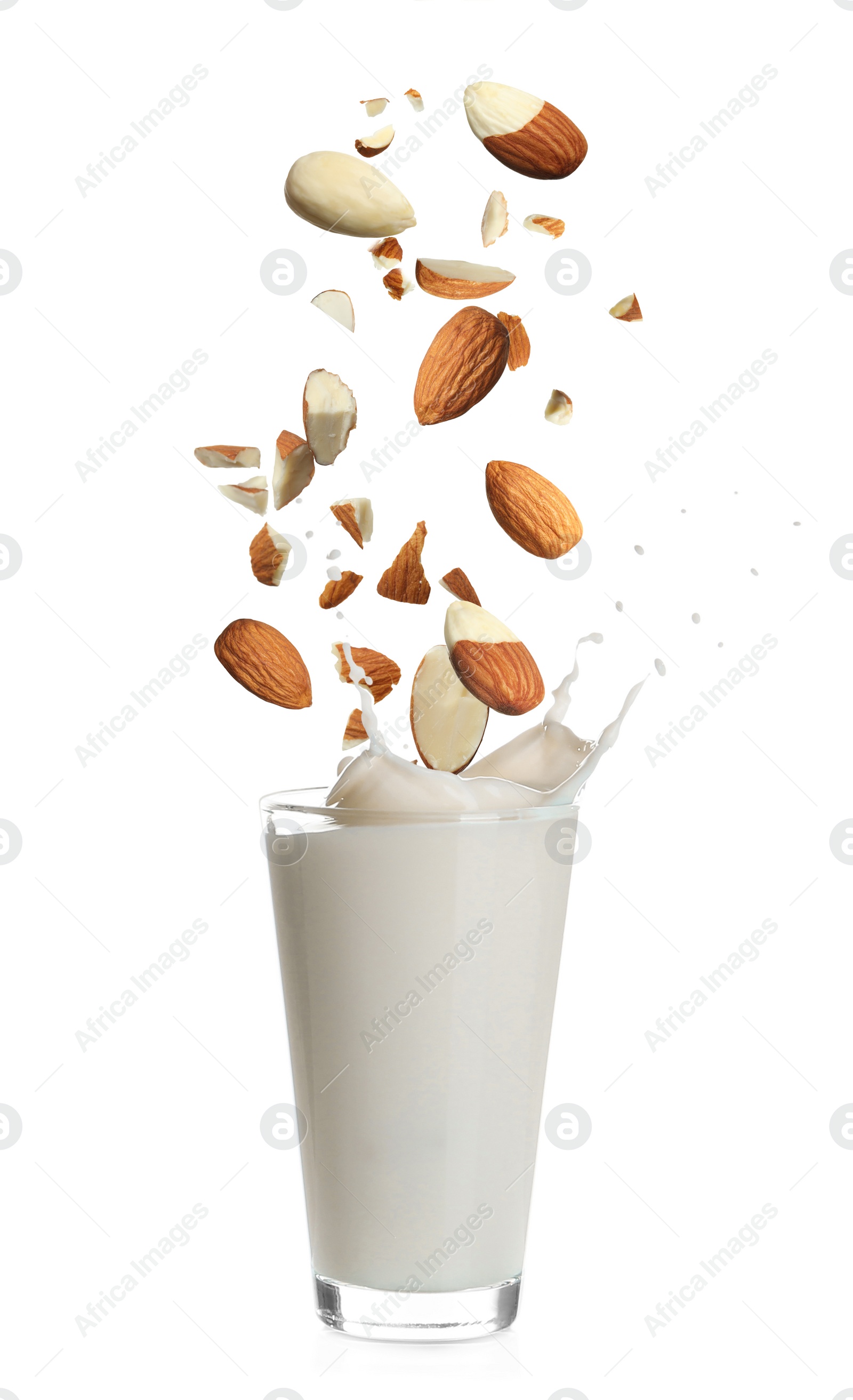 Image of Delicious almond milk and nuts on white background