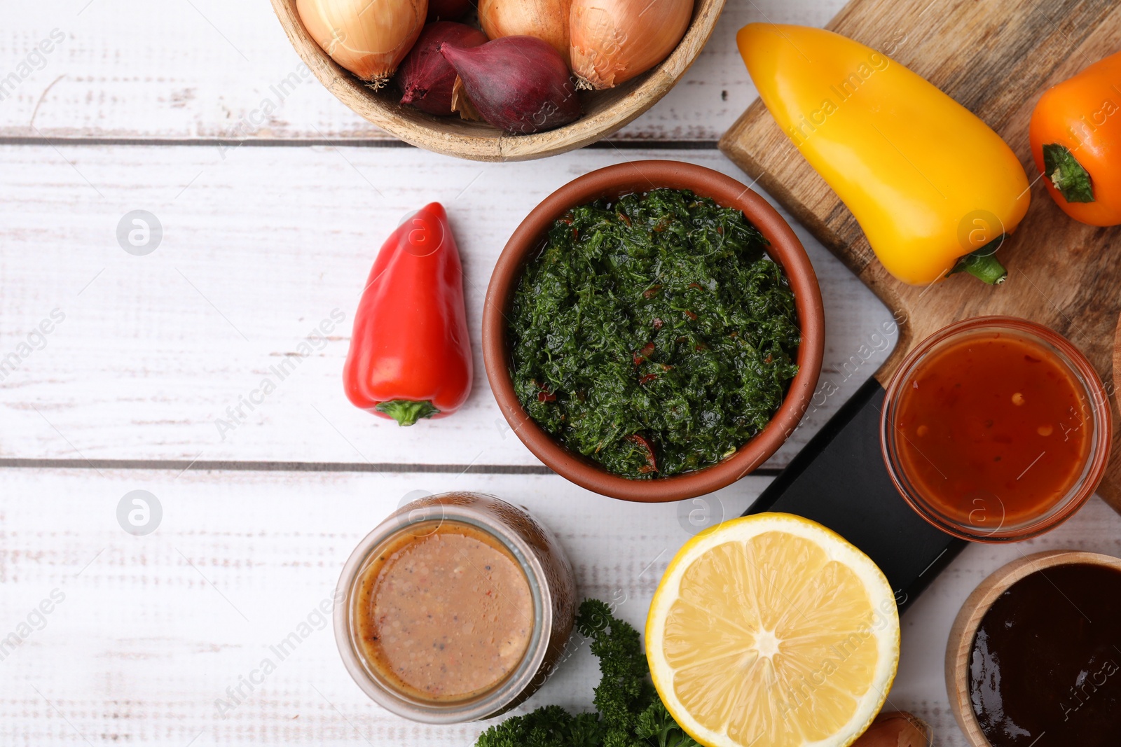 Photo of Different fresh marinades and ingredients on white wooden table, flat lay. Space for text