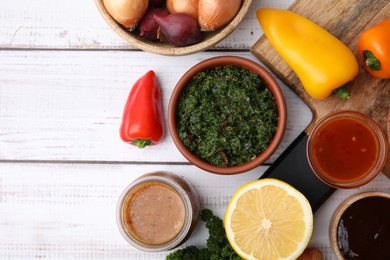 Photo of Different fresh marinades and ingredients on white wooden table, flat lay. Space for text