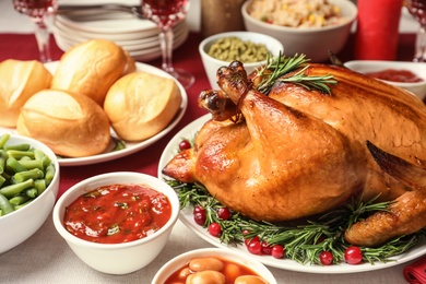 Photo of Traditional festive dinner with delicious roasted turkey served on table