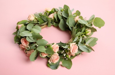 Photo of Wreath made of beautiful flowers on pink background