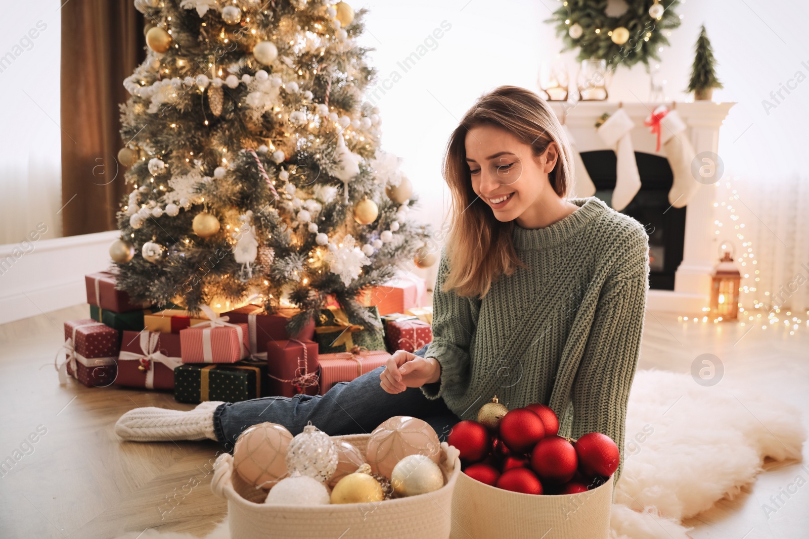 Photo of Beautiful woman decorating Christmas tree at home