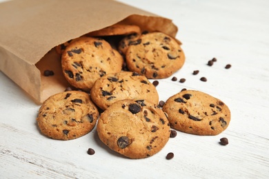 Photo of Delicious chocolate chip cookies on wooden table