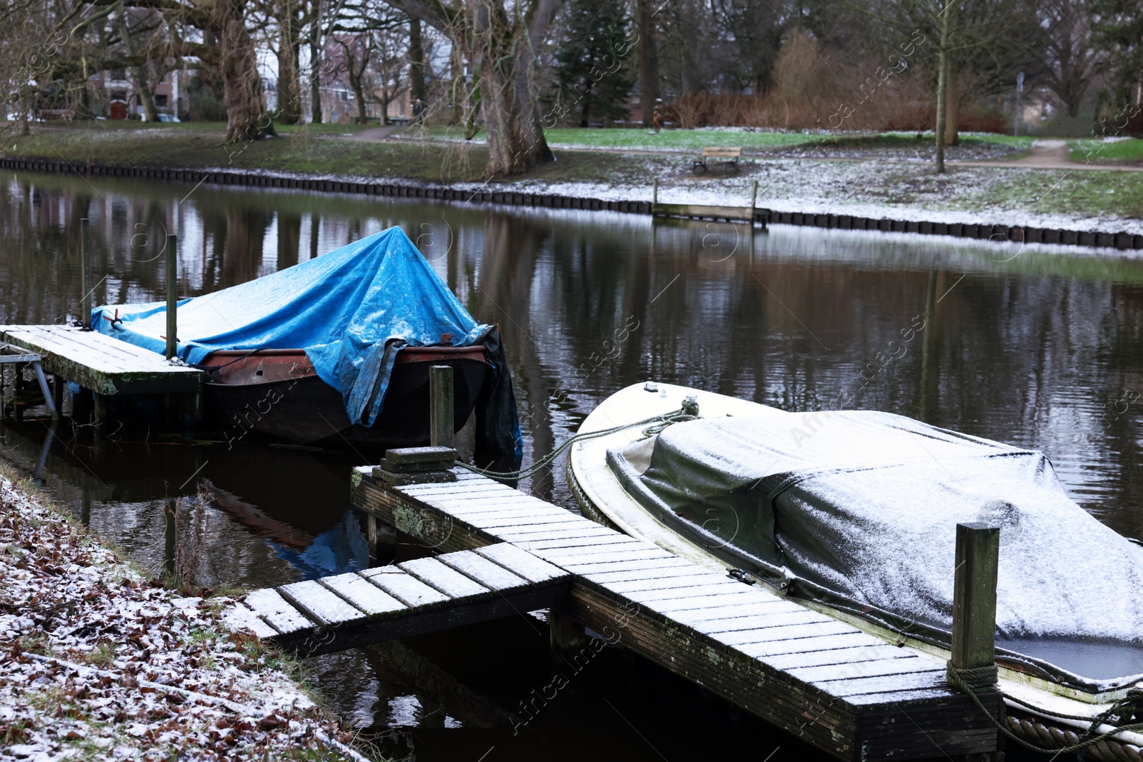 Photo of Water canal with moored boats on winter day