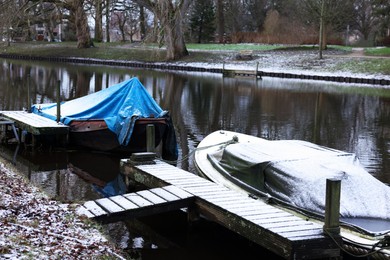 Water canal with moored boats on winter day