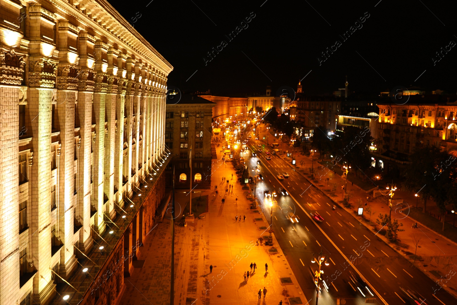 Photo of KYIV, UKRAINE - MAY 22, 2019: Beautiful view of illuminated Khreshchatyk street with road traffic and City Council building