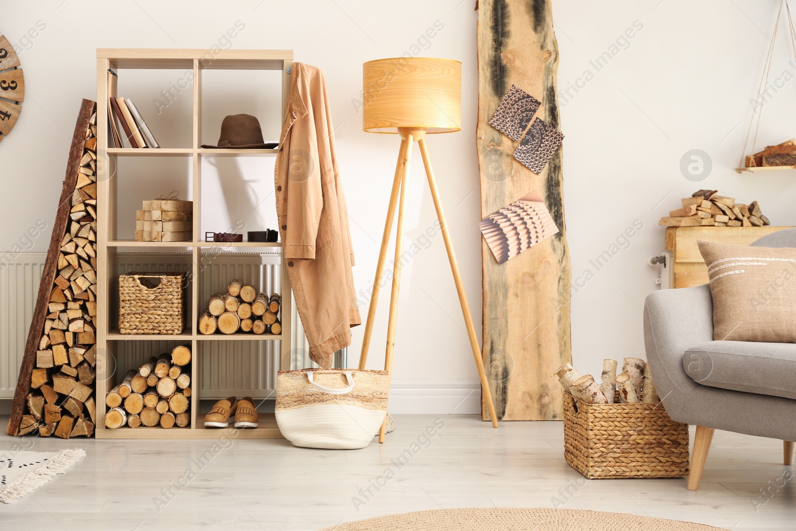 Photo of Stylish room interior with firewood as decorative element