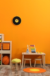 Photo of Stylish children's room interior with toys and new furniture