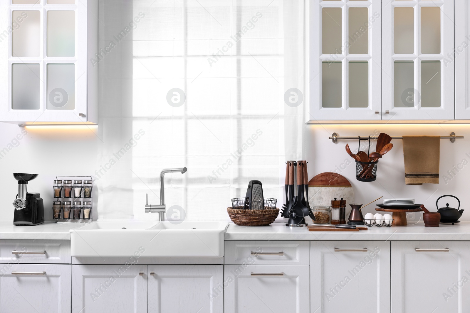 Photo of Set of different utensils and dishes on countertop in kitchen