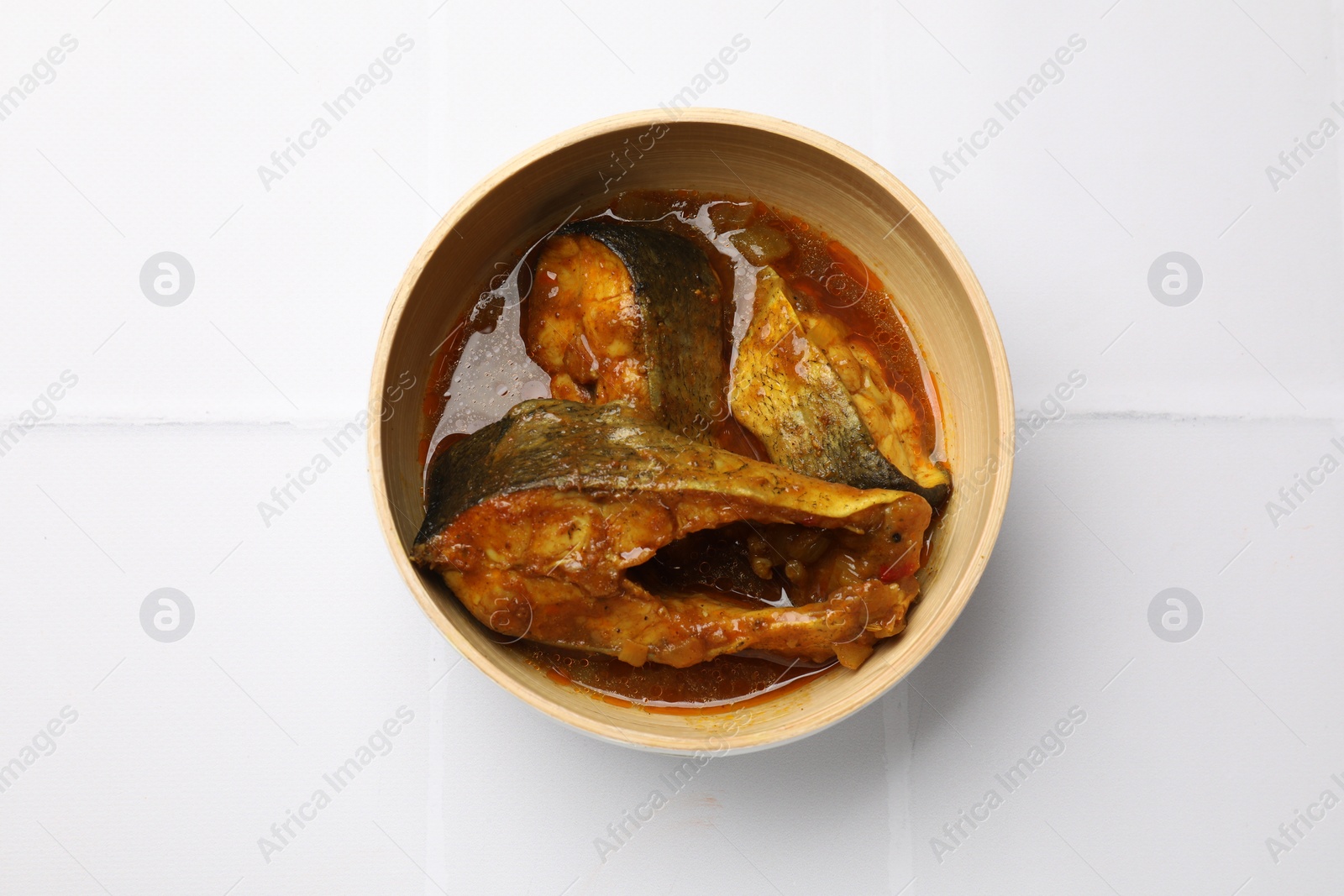 Photo of Tasty fish curry on white background, top view. Indian cuisine