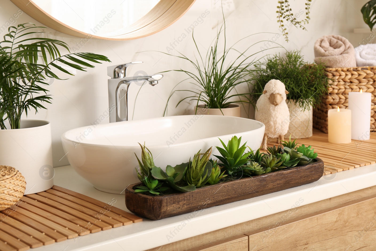 Photo of Counter with sink and many different houseplants near white marble wall