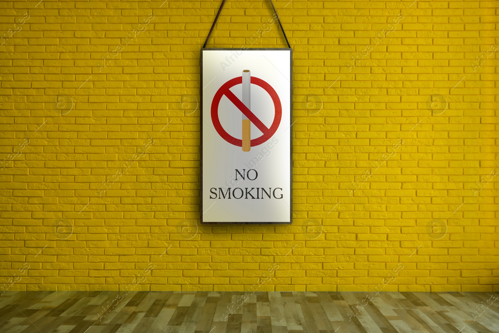 Image of Sign No Smoking hanging on yellow brick wall