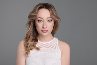 Portrait of beautiful woman on grey background