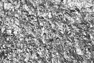 Photo of Crumpled silver foil as background, closeup view