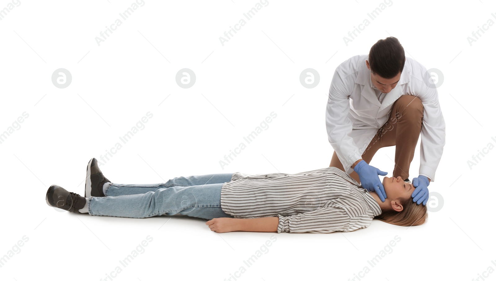 Photo of Doctor in uniform practicing first aid on woman against white background