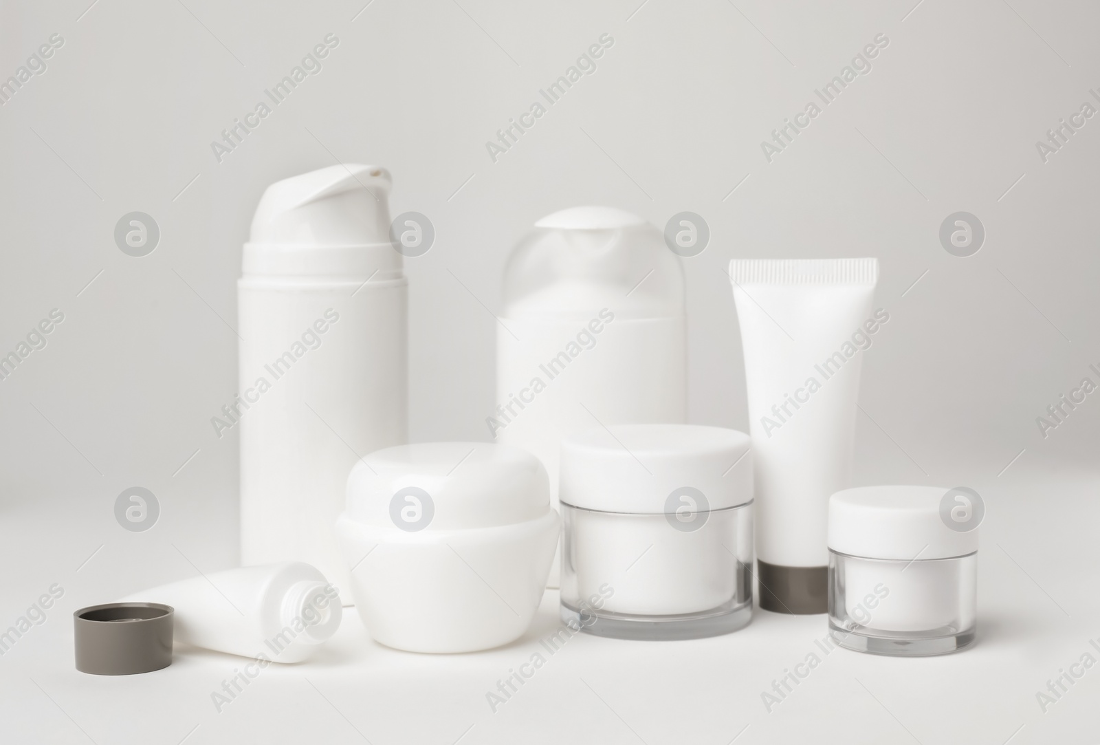 Photo of Composition with cosmetic products on light background