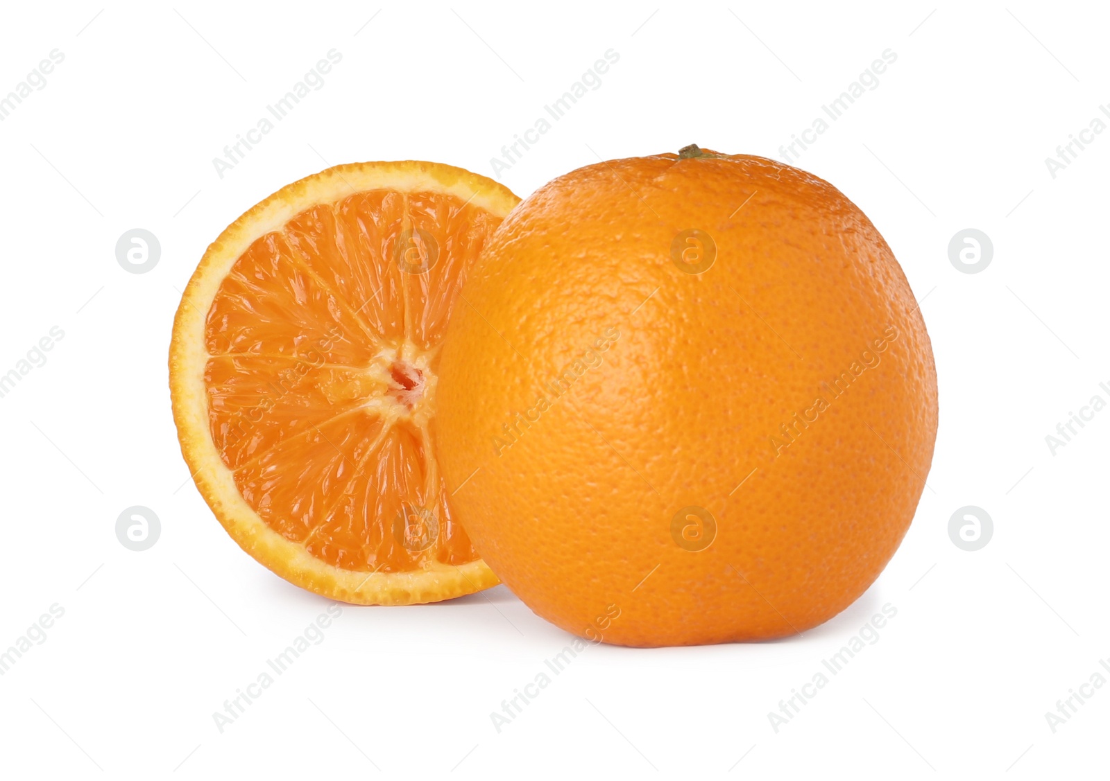 Photo of Cut and whole ripe oranges on white background