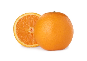 Photo of Cut and whole ripe oranges on white background
