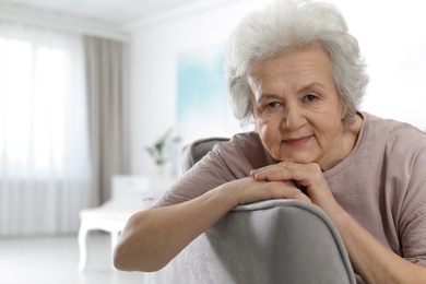 Portrait of mature woman in living room