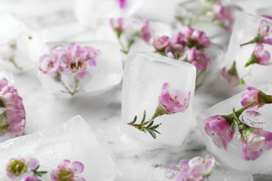 Photo of Floral ice cubes on marble table