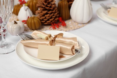 Photo of Beautiful autumn place setting with blank card and decor for festive dinner on table