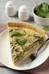 Piece of delicious spinach pie served on light table