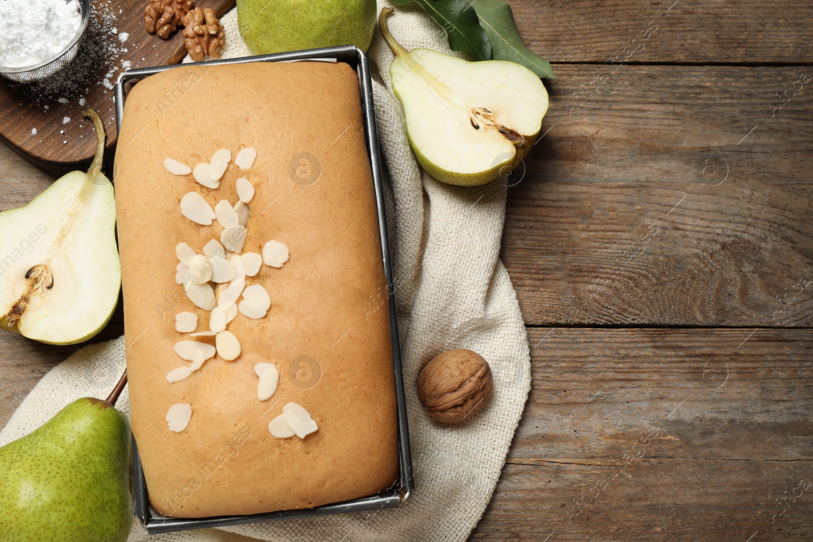 Photo of Flat lay composition with pear bread on wooden table, space for text. Homemade cake