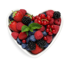 Mix of berries in heart shaped bowl isolated on white, top view