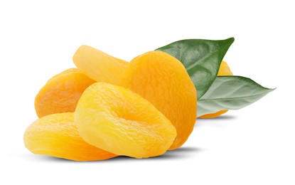 Image of Tasty dried apricots and green leaves on white background