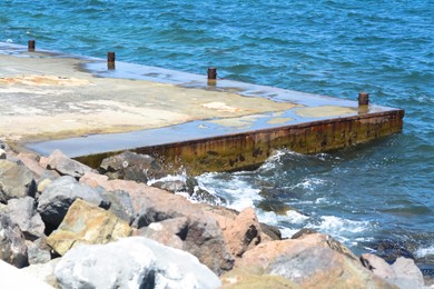 Photo of Beautiful concrete pier in sea on sunny day