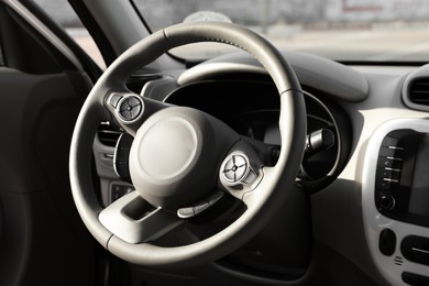 Black steering wheel and dashboard in modern car